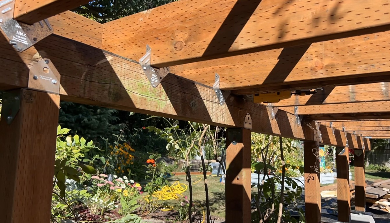 Wooden pergola with lattice shade structure over backyard deck in Hawthorne